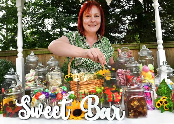 Lee Hubbard mans the Sweet Bar at Tanglewood Care Home's summer fair. Photos: Mick Fox