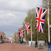 Union flags hanging from the street furniture outside Buckingham Palace on the Mall, London