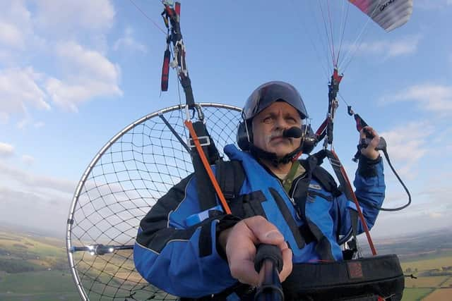 Tim takes a selfie mid-flight.