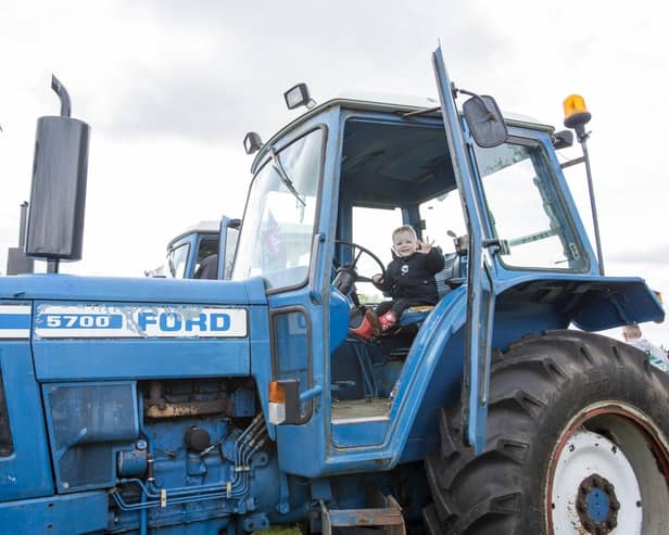 Theo Faupel, aged two, from Market Rasen, tries a tractor for size. Photo: Holly Parkinson