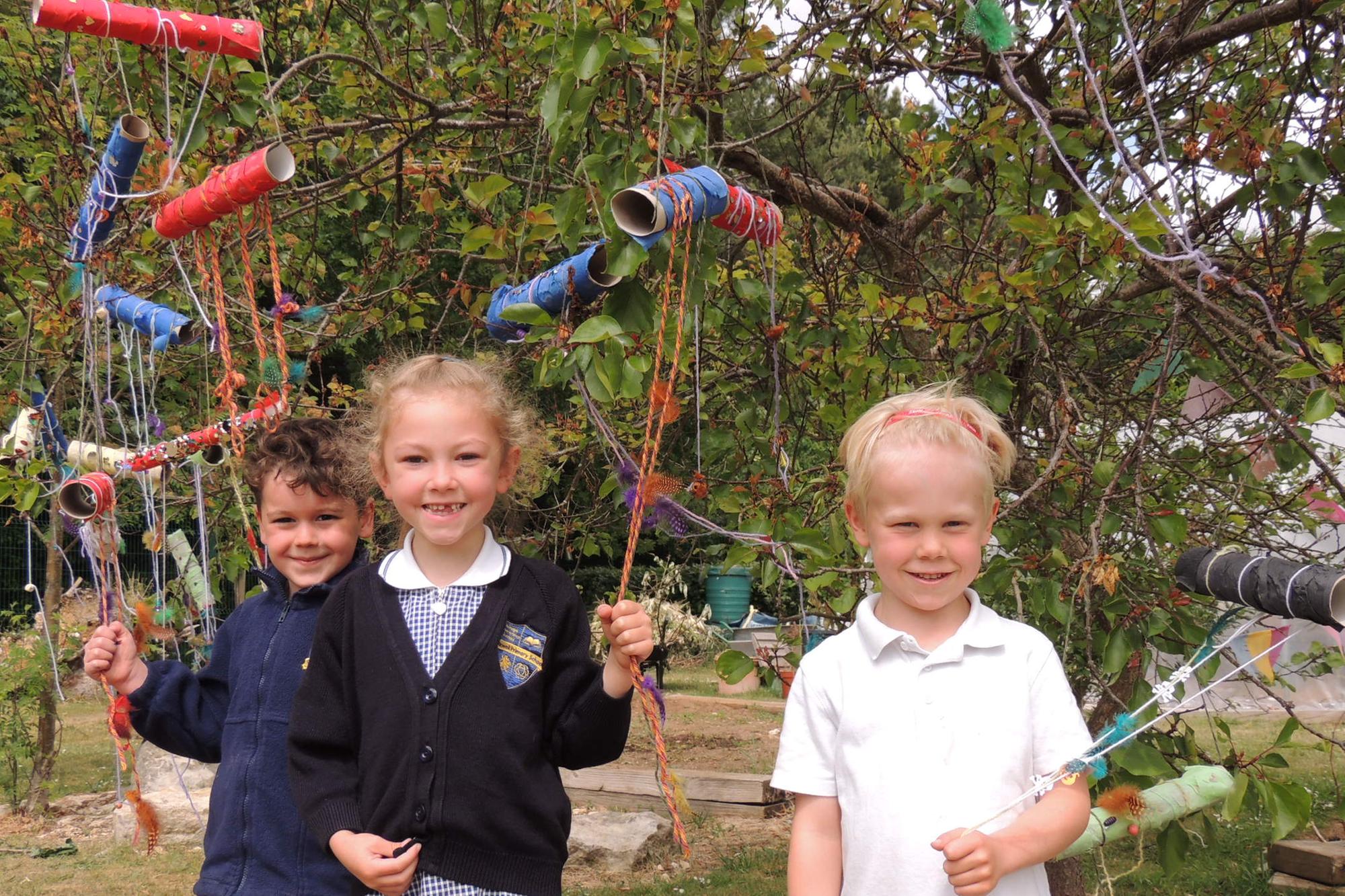L-R - Benjamin, Ava and Henry were some of the Year 1 and 2 pupils that made dream catchers to hang in the trees. Photo: AH