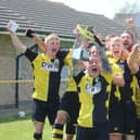 Colts skipper Grant Butler lifts the Lincs League trophy.