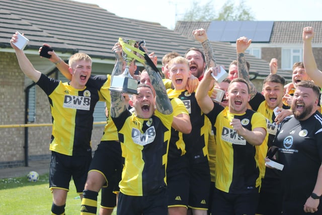 Colts skipper Grant Butler lifts the Lincs League trophy.