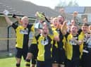 Colts skipper Grant Butler lifts the Lincs League trophy.