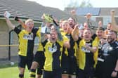 Colts skipper Grant Butler lifts the Lincs League trophy.