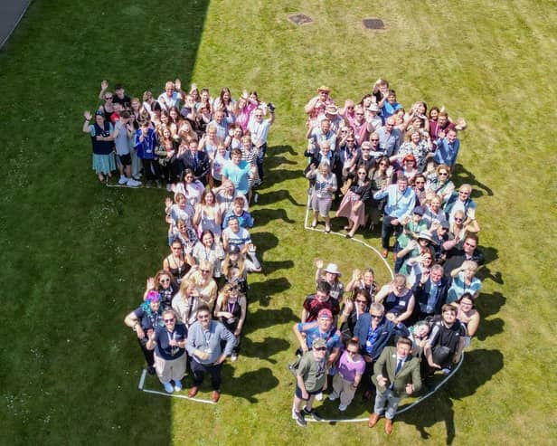 Students, staff and guests at Risefest lined up in the shape of the number 75 to represent Riseholme College's 75th anniversary.