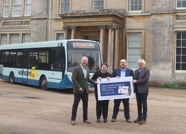 Pictured from left: Coun Tim Mitchell, cabinet member for connectivity; Holly Mumby-Croft, Scunthorpe MP; Karl Robinson, Hornsby Travel general manager; and Coun Carl Sherwood, cabinet member for safer, stronger communities – rural, in front of Normanby Hall. Image: North Lincs Council
