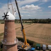 The cap is lowered onto the tower of Sibsey Trader Windmill.