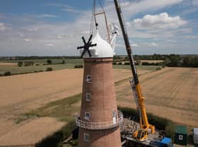 The cap is lowered onto the tower of Sibsey Trader Windmill.