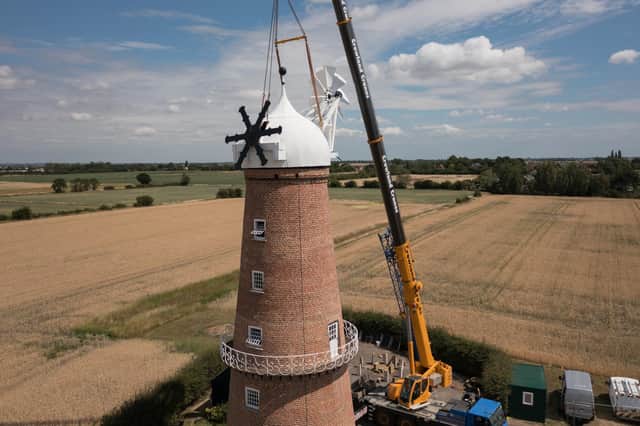 The cap is lowered onto the tower of Sibsey Trader Windmill.