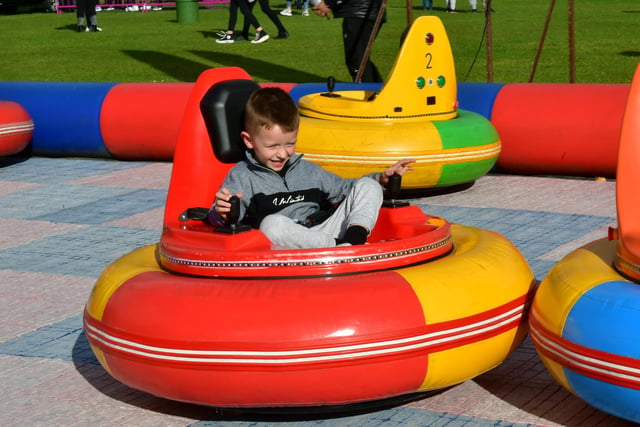 Archie Cross, aged four, of Boston, has a go at one of the fun fairground attractions.