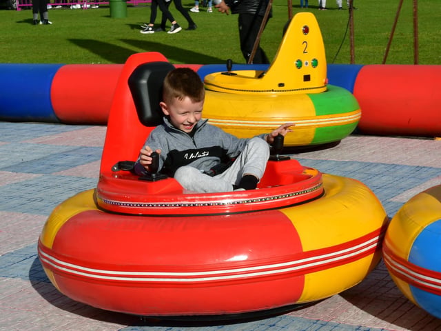 Archie Cross, aged four, of Boston, has a go at one of the fun fairground attractions.
