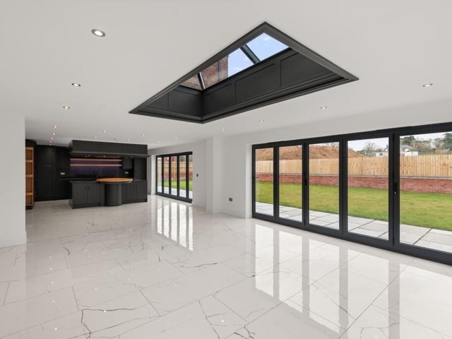 Looking across the open-plan kitchen and living area towards the kitchen.