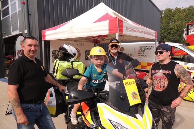 Joshua Busby, four, has a ride watched by LEBBS volunteers Jamie Finn (left) and Stephen Challoner, and dad Stefan Busby (right).