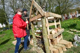 Ethan Scott, aged 12, and Adam Flemming making a Bug Hotel