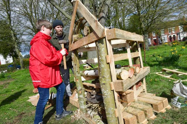Ethan Scott, aged 12, and Adam Flemming making a Bug Hotel