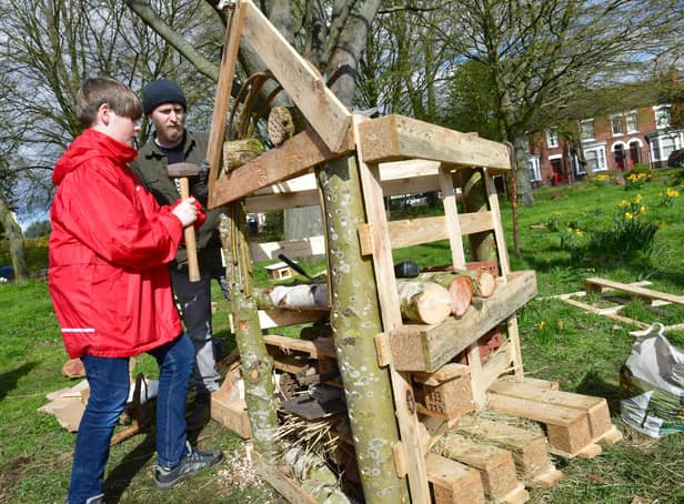 Ethan Scott, aged 12, and Adam Flemming making a Bug Hotel