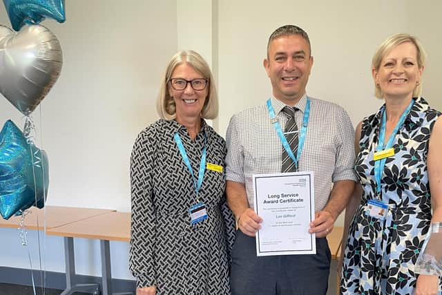 Lee (centre) receiving his award from Elaine Baylis (left) and Professor Karen Dunderdale (right)