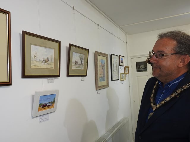 Mayor of Sleaford, Coun Dave Darmon admiring some of the pieces on a rural theme.