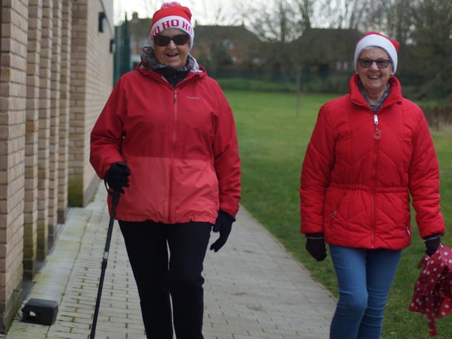 All smiles from these Santa's as they stroll in