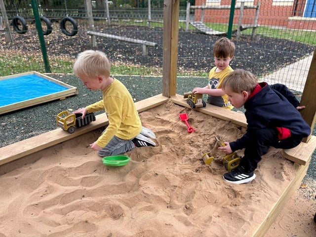 children playing in their new sand pit