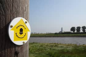 A King Charles III England Coastal Path waymark.
