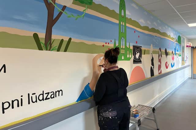 The Painting Lady, Michelle Codling, hard at work on the mural