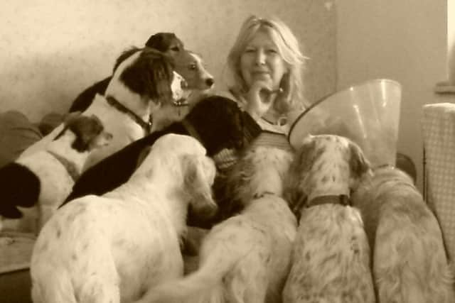 Jacqui enjoys a snack - watched by an audience of dogs.