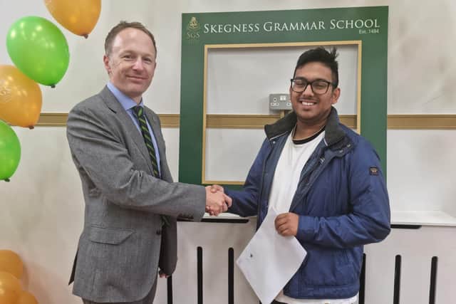 Skegness Grammar School Executive Headmaster Jude Hunton congratulates Yusuf Ahmed.