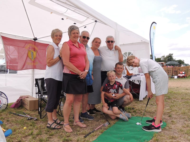 South Kyme Golf Club members on their stand with Natalie Dewhurst, nine, of Heckington trying the putting challenge.