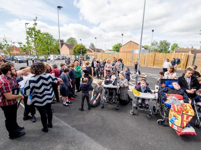 School staff, pupils and supporters gather outside the new school building as it is officially opened.