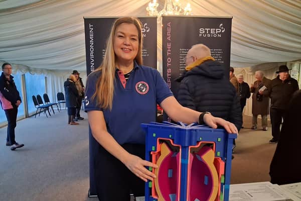 Katy Jarvis-Morgan, STEP's site stakeholder manager, with a model of the fusion reactor at a consultation event in Gainsborough