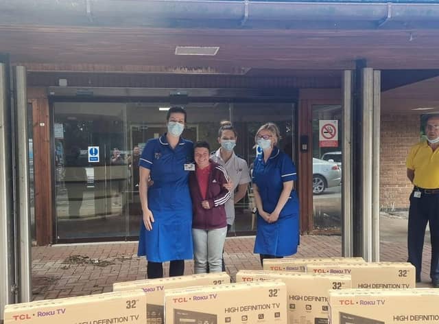 PCSO Michelle Collins delivering television sets to staff at the Bostonian.