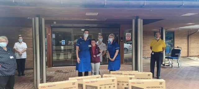 PCSO Michelle Collins delivering television sets to staff at the Bostonian.