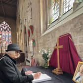 Chairman of NKDC Coun Lucille Hagues, signs the book of condelence for the Queen at St Denys' Church, Sleaford, on Friday.