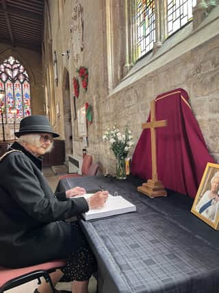 Chairman of NKDC Coun Lucille Hagues, signs the book of condelence for the Queen at St Denys' Church, Sleaford, on Friday.