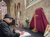 Chairman of NKDC Coun Lucille Hagues, signs the book of condelence for the Queen at St Denys' Church, Sleaford, on Friday.