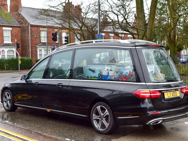 The hearse makes its way up Tunnard Street