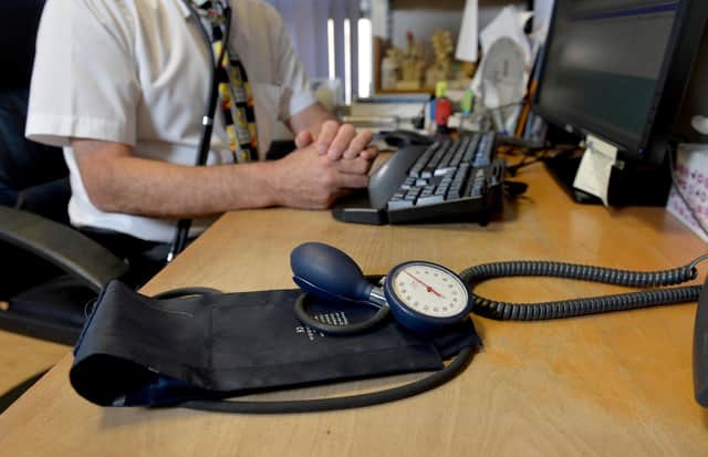 File photo dated 10/09/14 of a GP at their desk. GP appointments over the phone or online can miss serious illnesses and put patients at risk, according to a new study. Researchers said mistakes via remote consultation are rare, but there is a risk of patients being under-diagnosed, GPs being swayed by what has been said previously, and less qualified staff not acting on signs of illness. Issue date: Wednesday November 29, 2023.