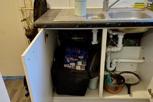 The bag of illegal cigarettes found under a sink. Photo: Lincs Police