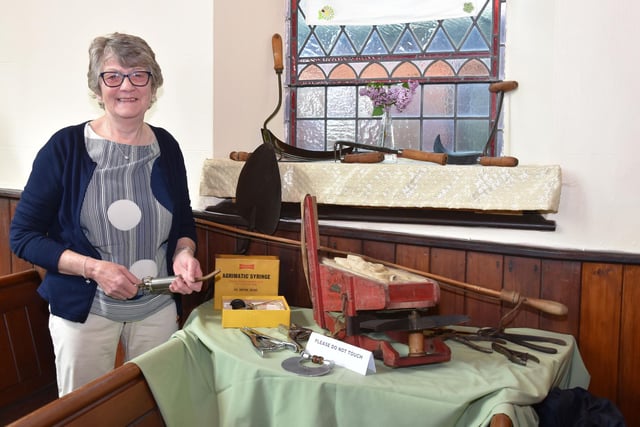 Sue Johnson with old farm tools including a fiddle drill