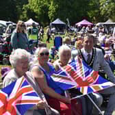 Flying the flag for the greatest generation - Mayor Coun Adrian Findley chats to members of the crowd.