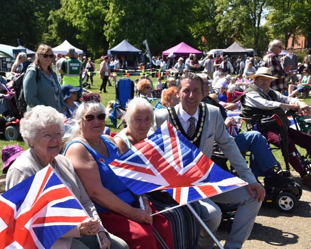 Flying the flag for the greatest generation - Mayor Coun Adrian Findley chats to members of the crowd.