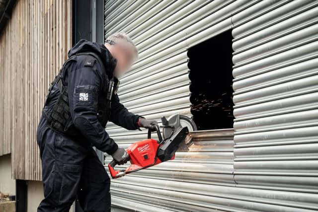 Officers cutting their way into the building. Picture:Lincolnshire Police