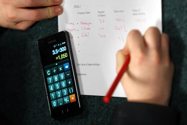 File photo dated 26/10/12 of of a pupil doing their maths homework as children who are good at maths at age 10 earn more later in life, new research suggests.