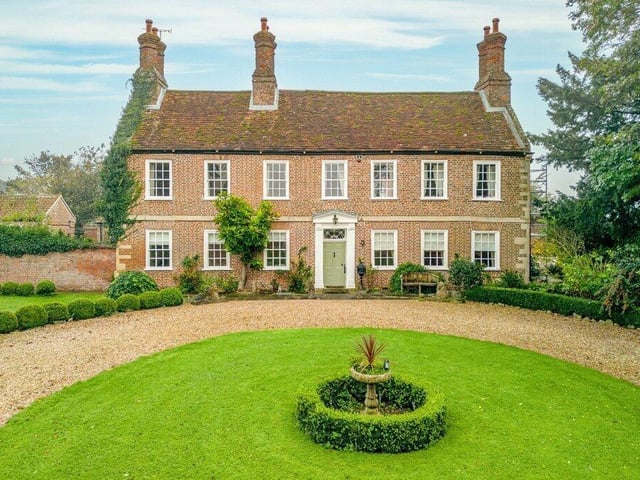 The front of the house and part of its turning circle.