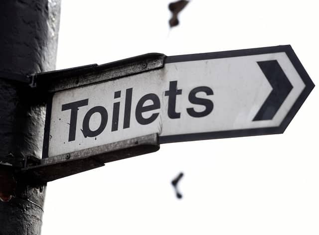 A sign for public toilets in London. Spending by councils in England on basic services such as public toilets, road safety and pest control has fallen as much as 40\% since 2010.