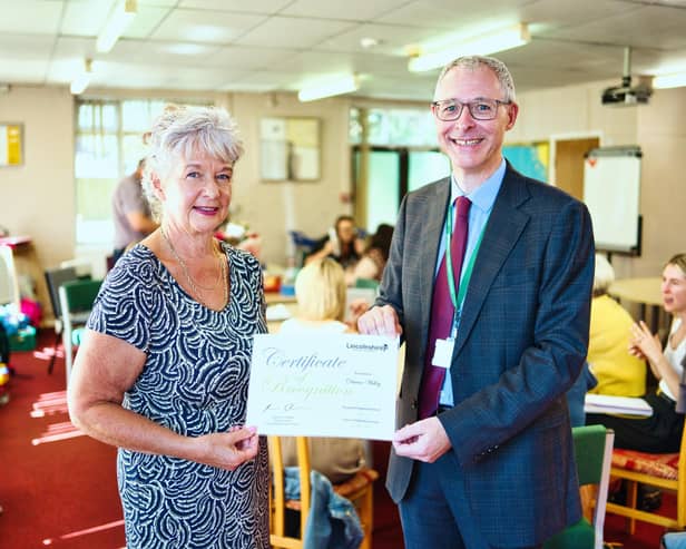 Dawn Willey, receiving a certificate of recognition, given 'in grateful appreciation of 50 years of dedicated services', with Martin Samuels, executive director for Adult Care and Community Wellbeing.