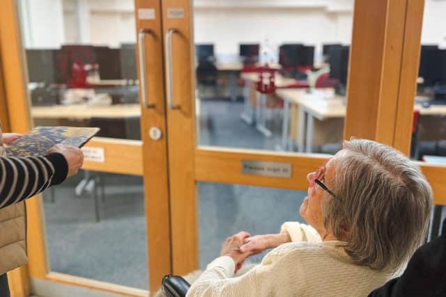 Beryl being given a tour around the school.