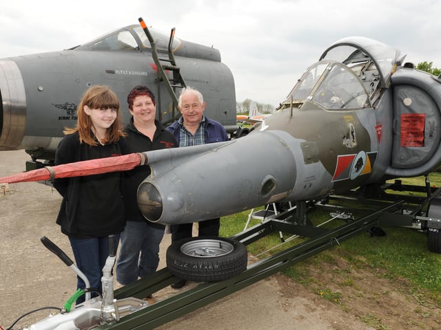 A scene from the annual Friends of Metheringham Airfield Open Weekend of 2014. Pictured (from left) Jessica Robertson, 14, and Penny Brooks, of Ruskington, and Jim Brooks, of Dorrington, with a Harrier GR3 cockpit.
